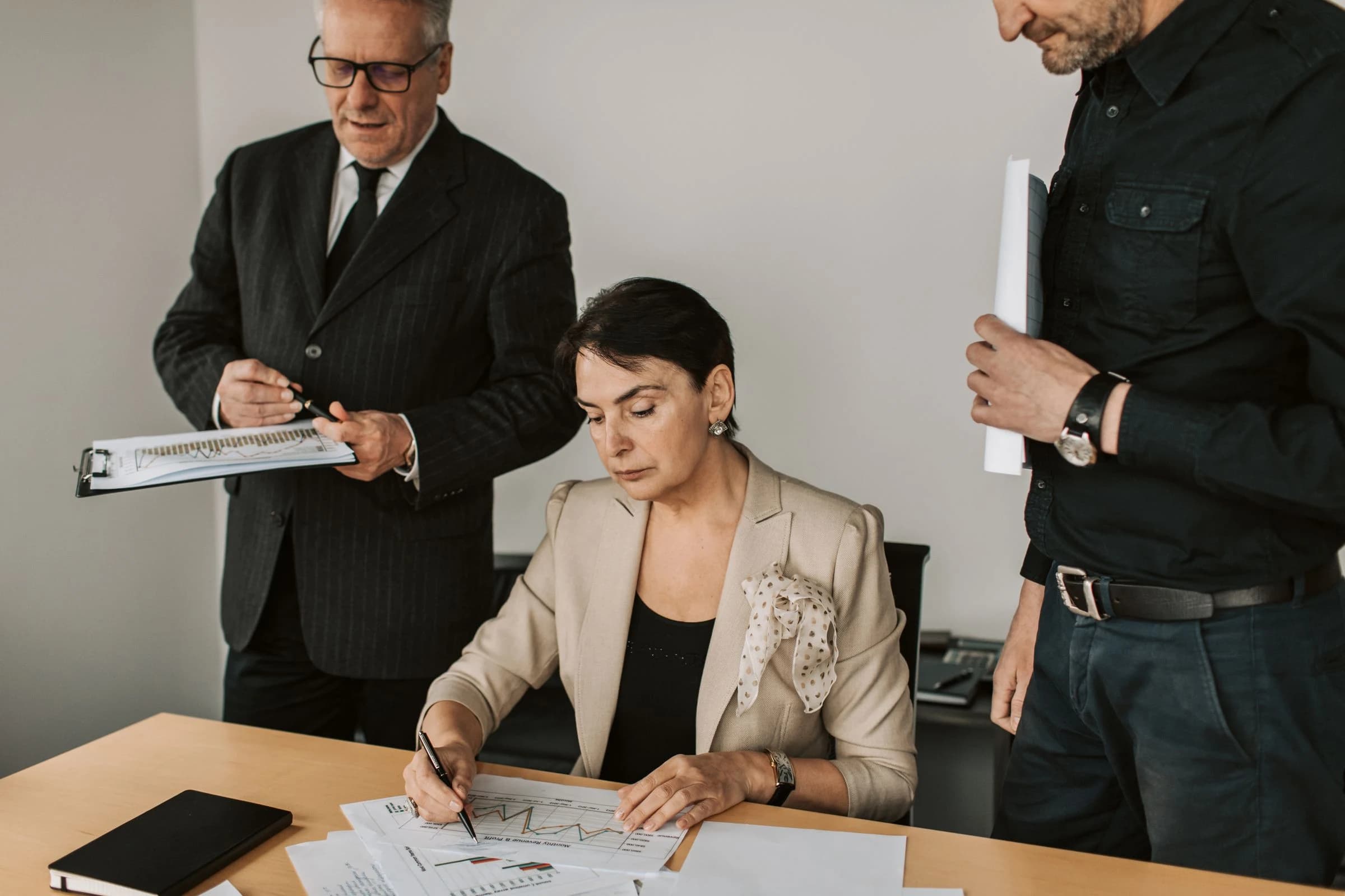 Executive reviewing a work plan with her colleagues