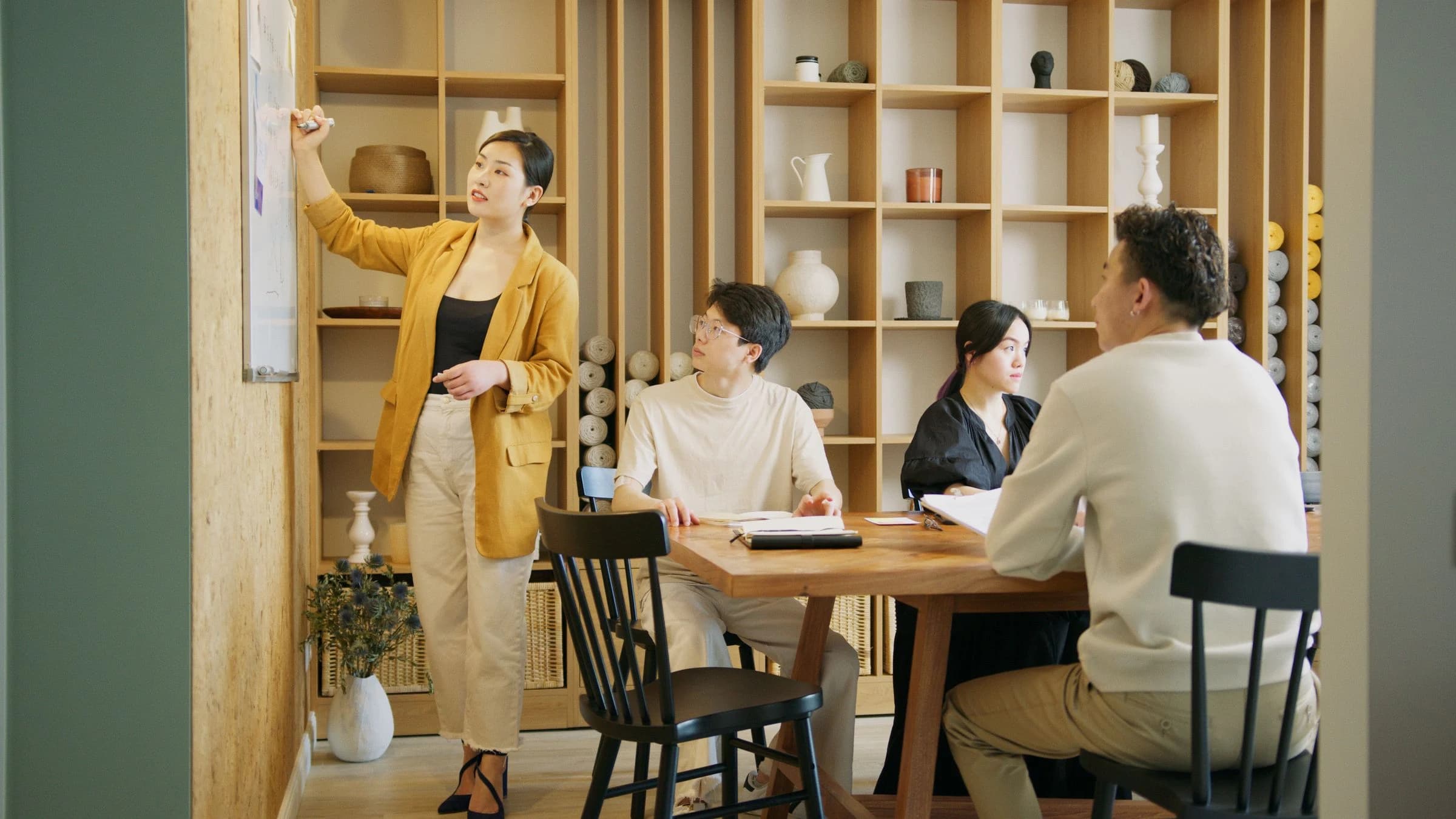 Colleagues discussing a work plan in a bright shared office
