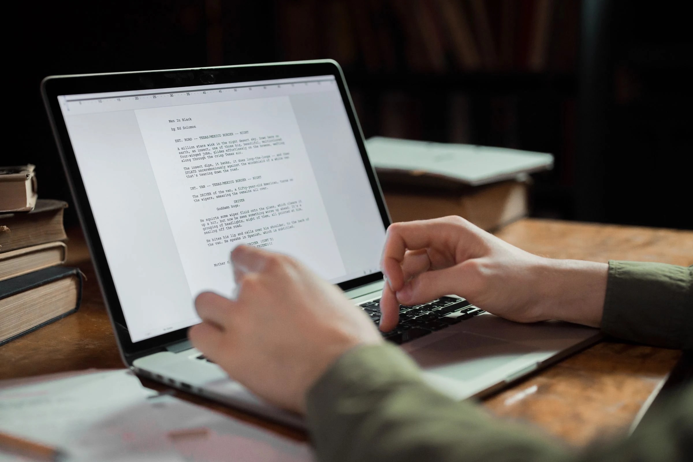 Professional reviewing written correspondence on a laptop