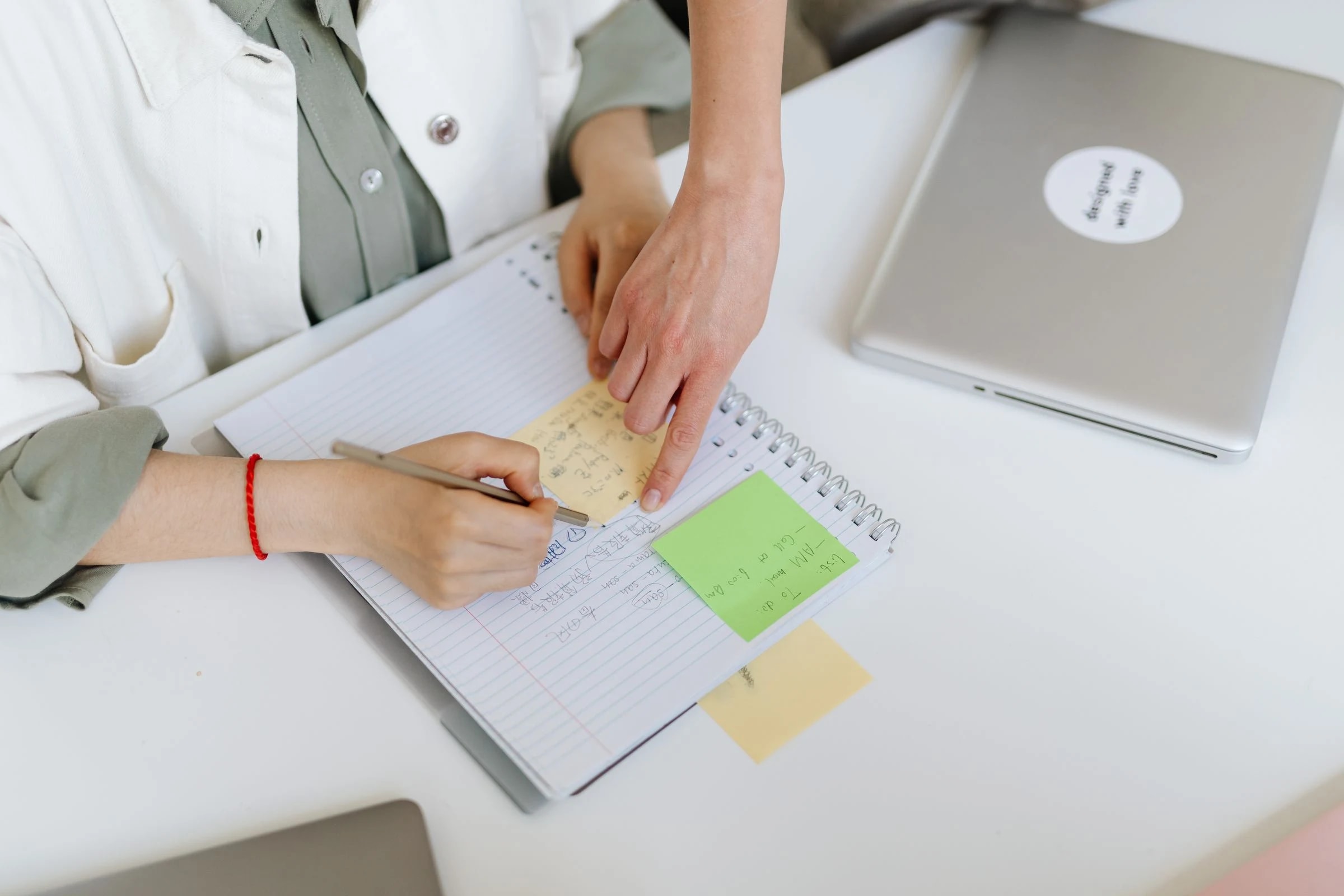 Colleagues organizing tasks with written notes