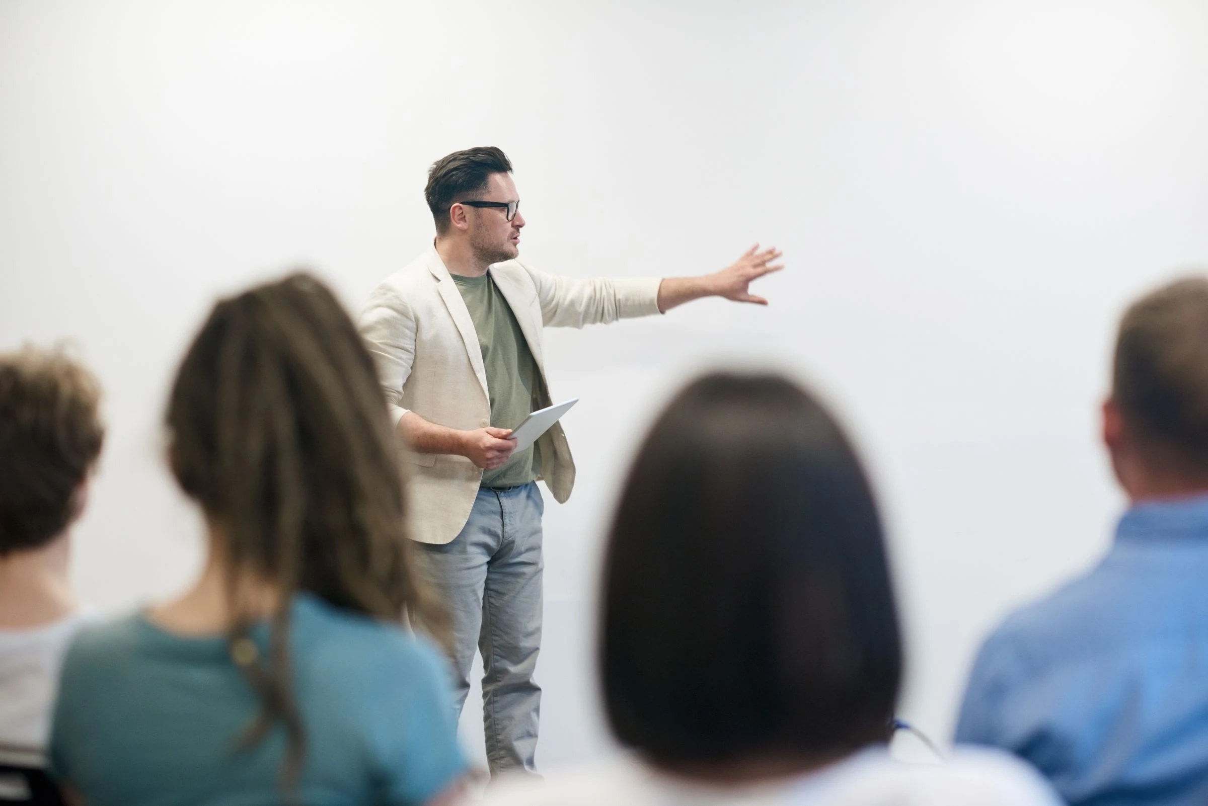 A presenter sharing ideas with colleagues in a bright meeting room
